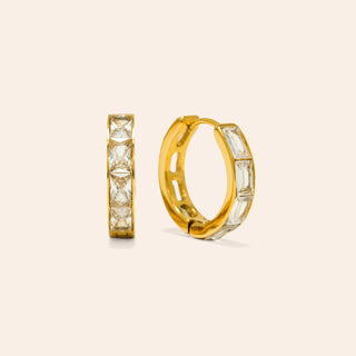 a pair of diamond gold hoop earrings.