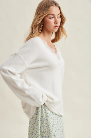 Woman wearing a white blouse with a neutral background