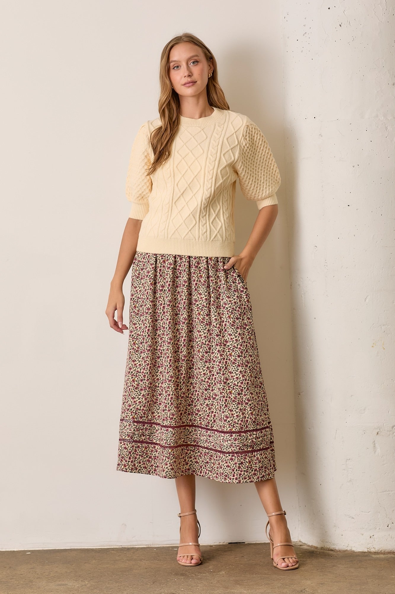 women wearing floral pattern skirt and a yellow sweater