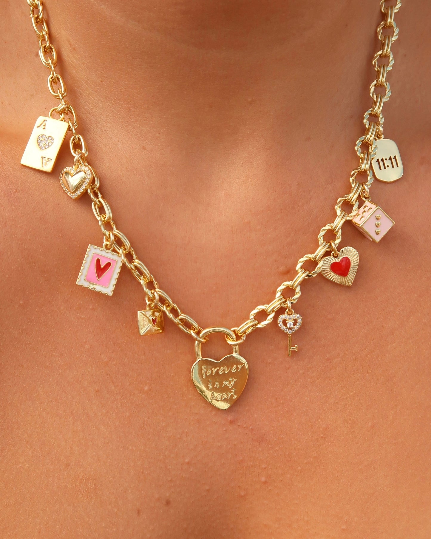 Gold necklace with various charms on a person's neck
