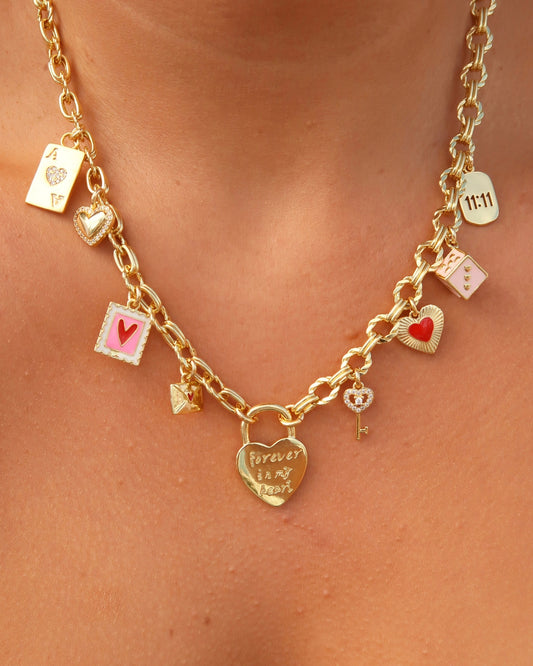 Gold necklace with various charms on a person's neck