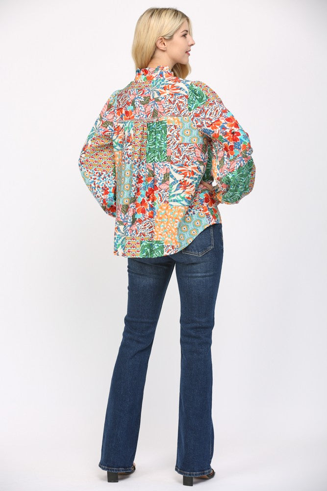 Women wearing a patterned blouse and blue jeans on a white background.