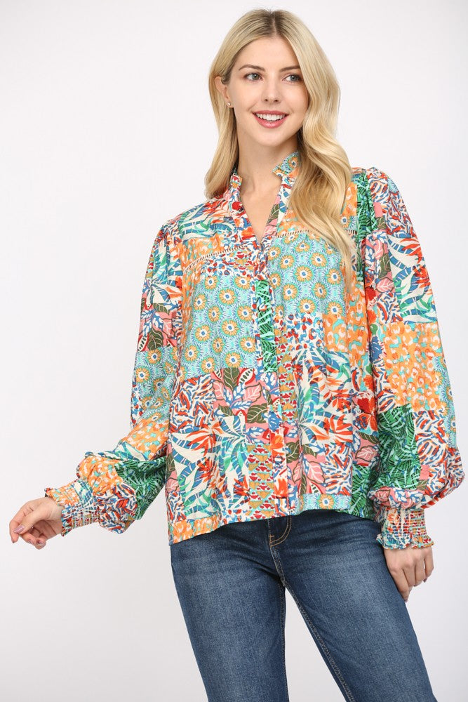 Women wearing a patterned blouse and blue jeans on a white background.