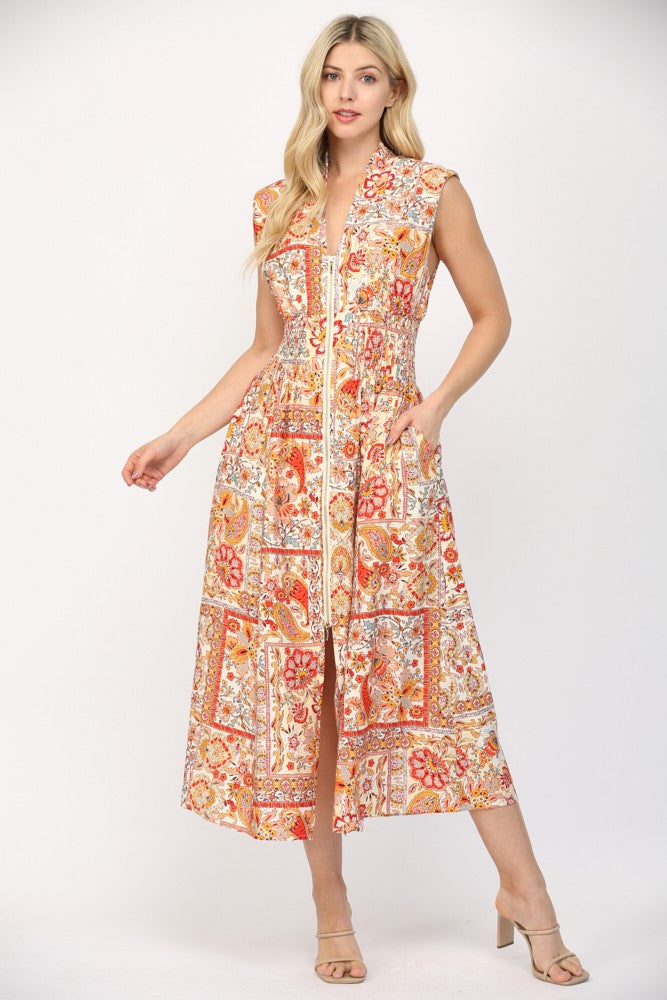 Women wearing a printed orange and cream summer dress.