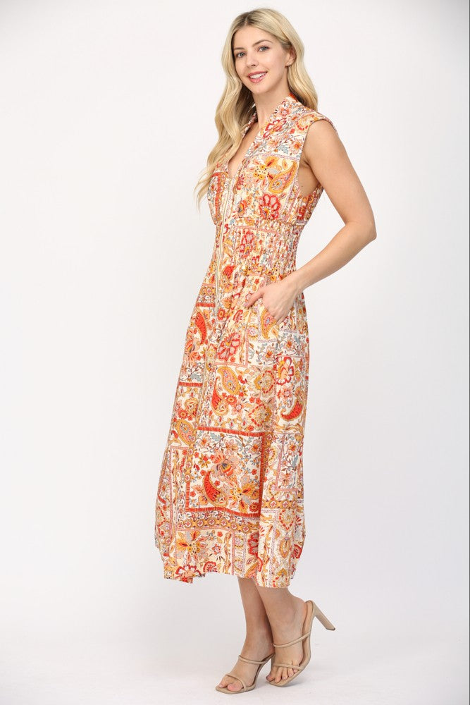 Women wearing a printed orange and cream summer dress.