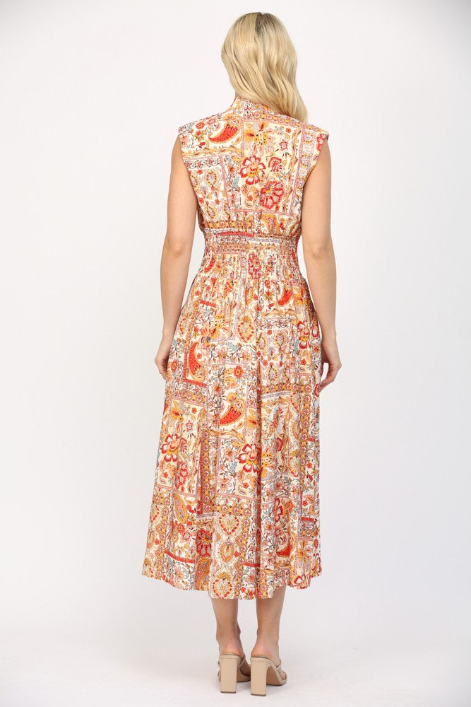 Women wearing a printed orange and cream summer dress.