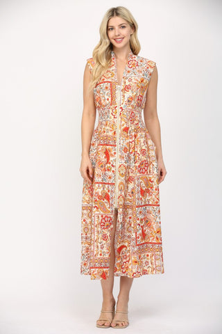 Women wearing a printed orange and cream summer dress.