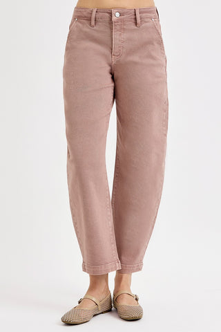 Pink jeans worn by a person on a white background