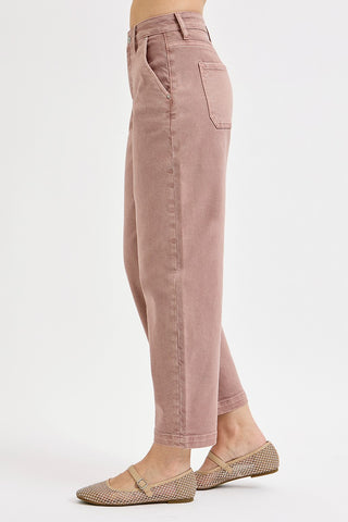 Pink pants worn by a person on a white background