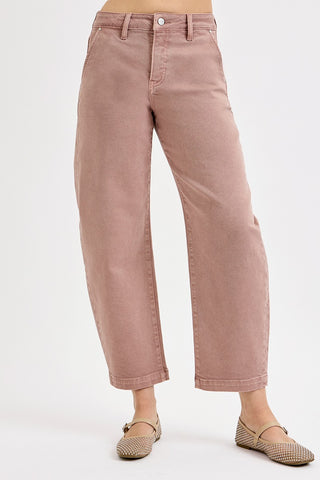 Pink jeans worn by a person on a white background