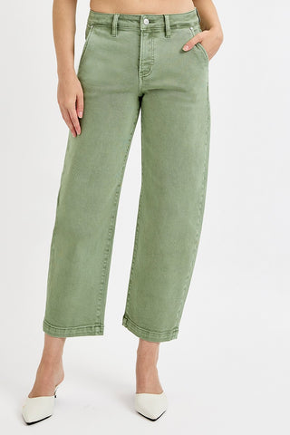 Person wearing green wide-leg jeans on a white background