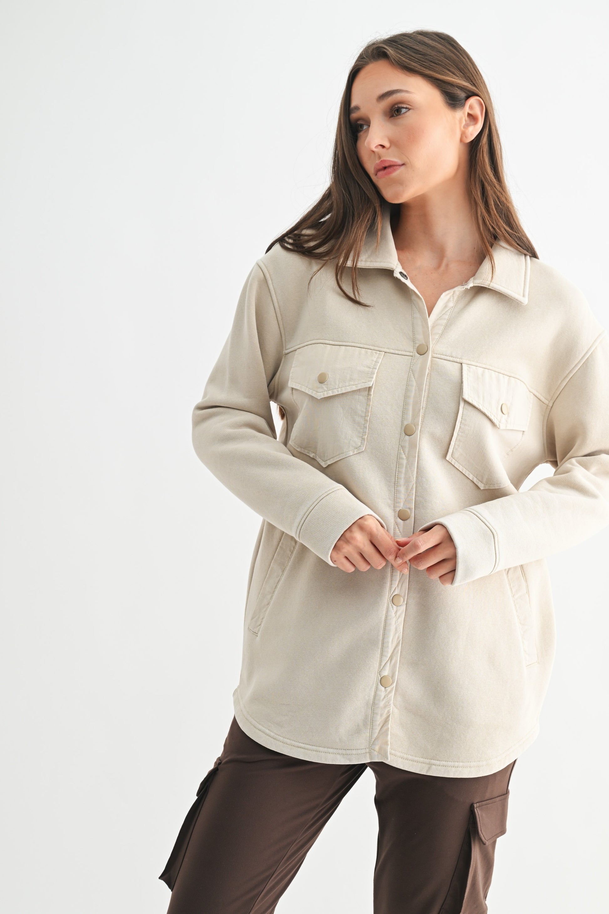 Woman wearing a beige jacket on a white background