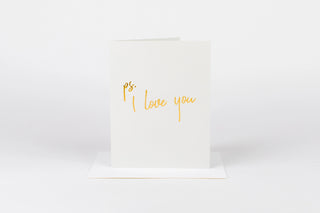 White card with 'ps. I love you' text in gold on a white background