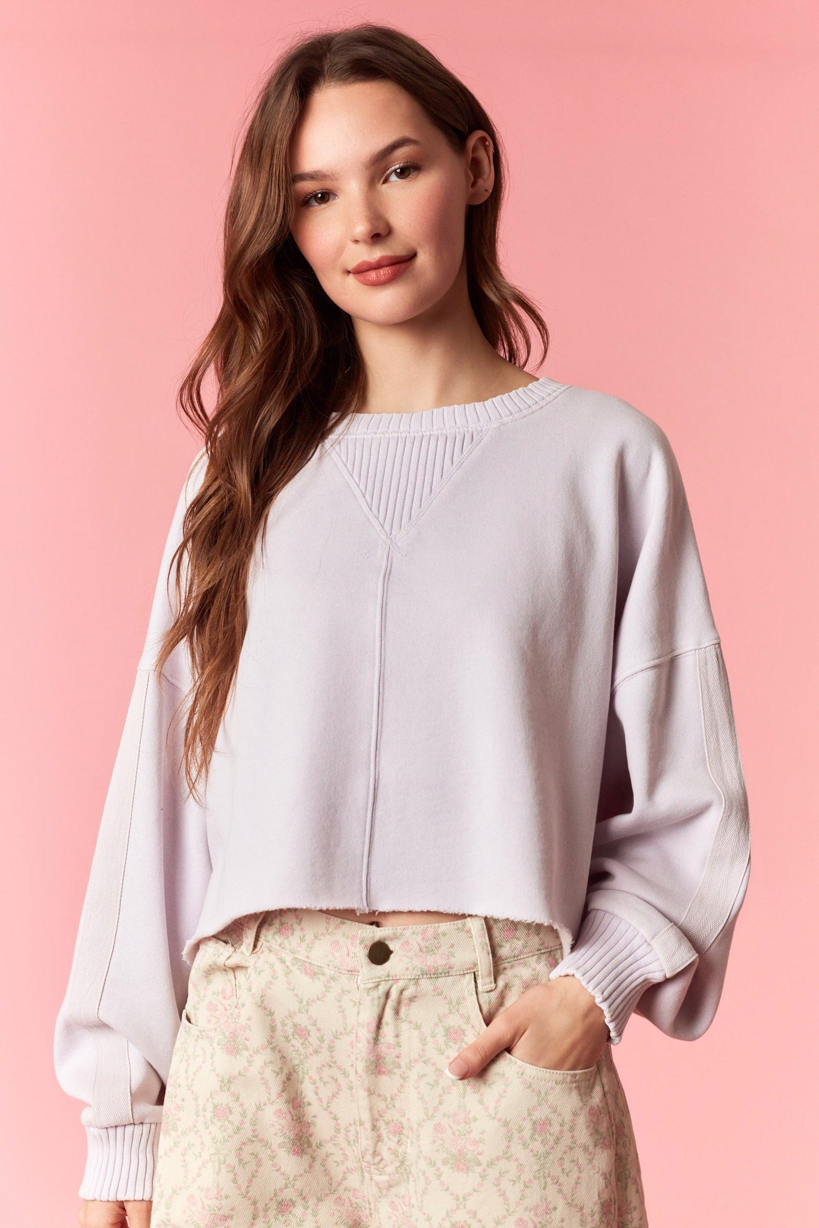 Women wearing a cropped lavender sweater
