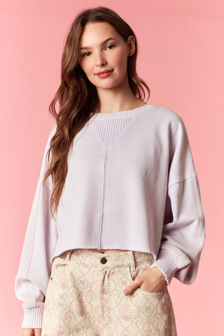 Women wearing a cropped lavender sweater