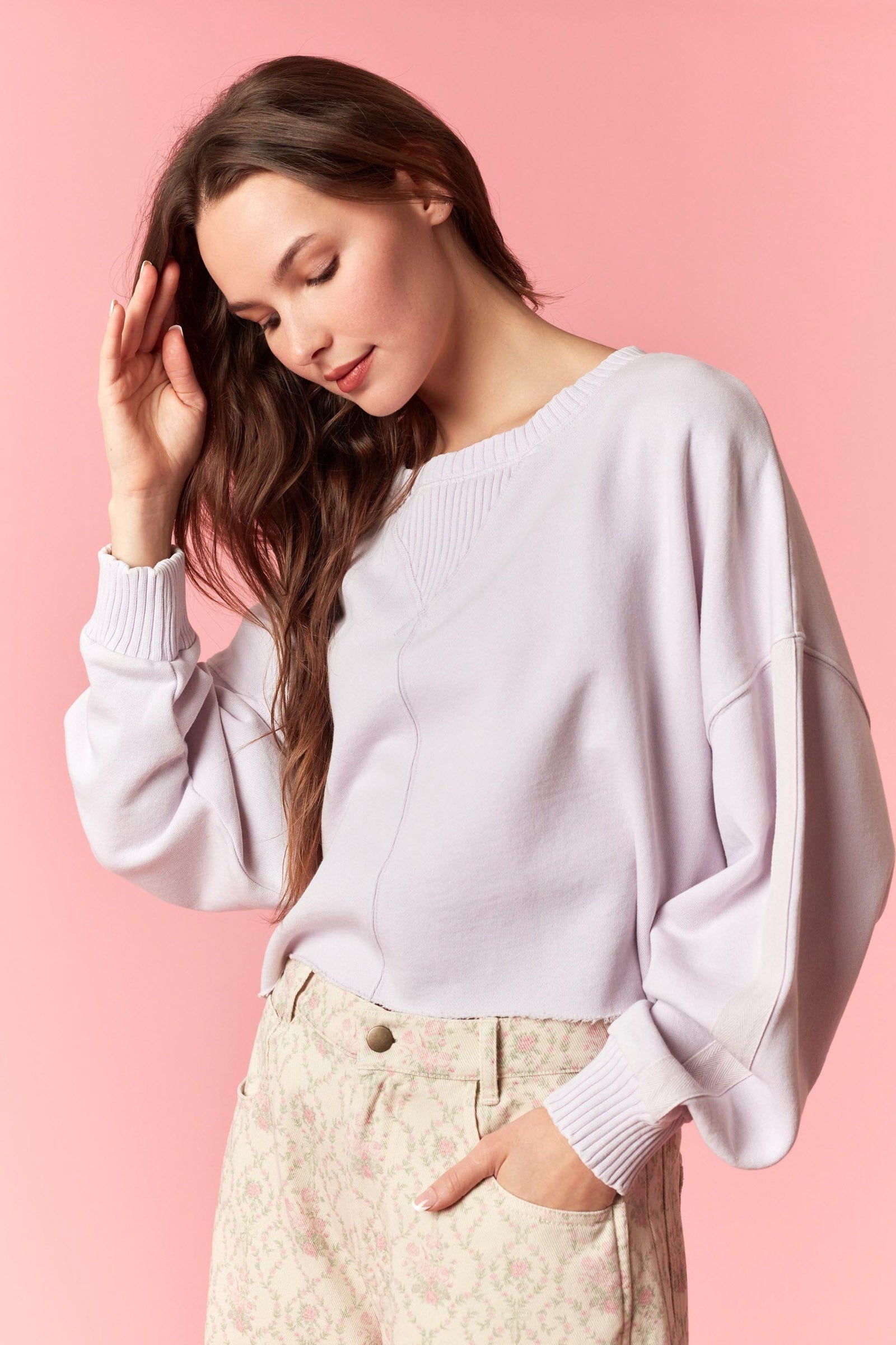 Women wearing a cropped lavender sweater