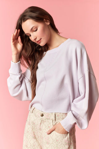 Women wearing a cropped lavender sweater