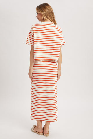 Woman wearing a red and white striped outfit on a white background