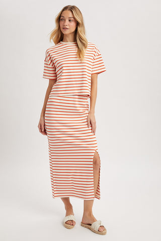 Woman wearing a red and white striped dress on a white background