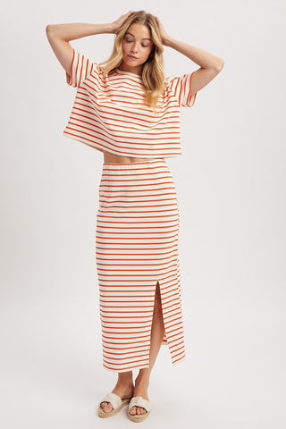 Woman wearing a red and white striped outfit on a white background