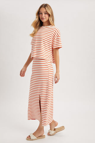 Woman wearing a red and white striped outfit on a white background