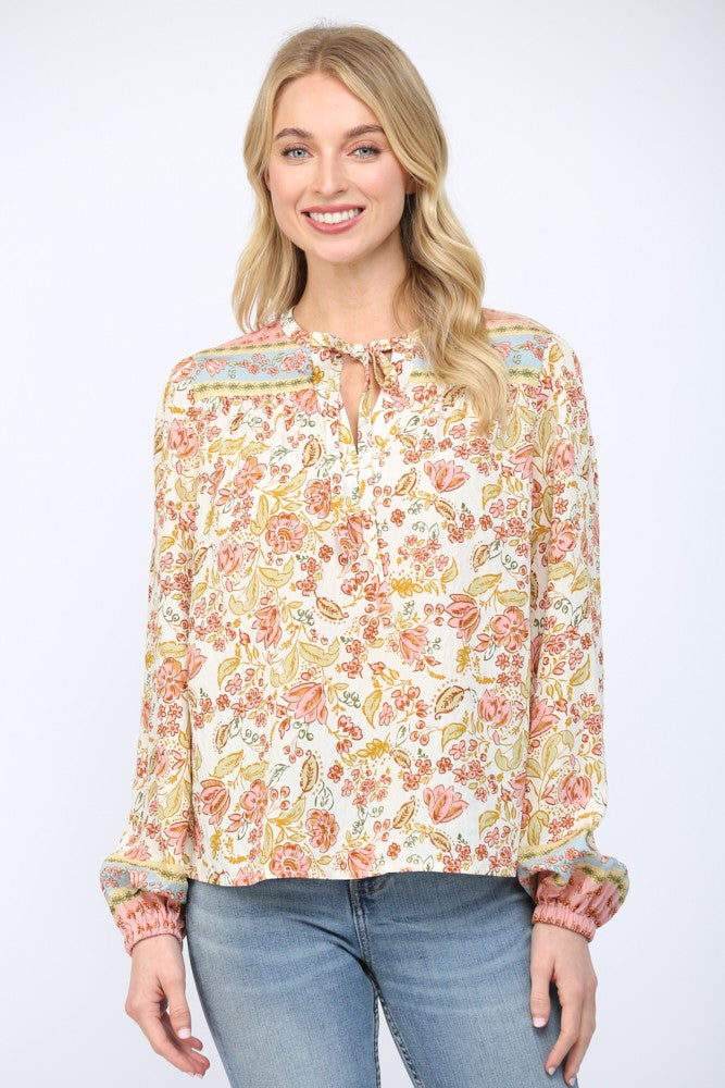 Women wearing a floral print blouse and blue jeans on a white background.