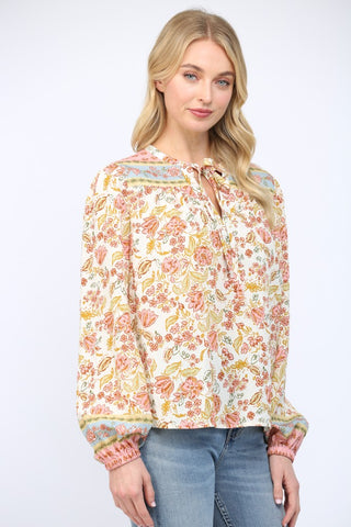 Women wearing a floral print blouse and blue jeans on a white background.