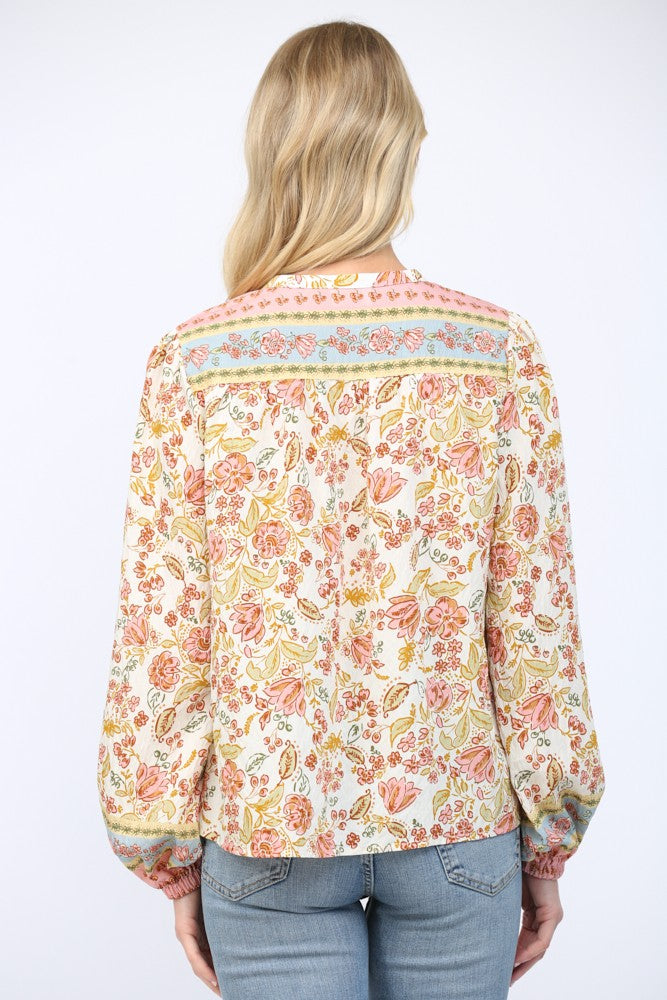 Women wearing a floral print blouse and blue jeans on a white background.