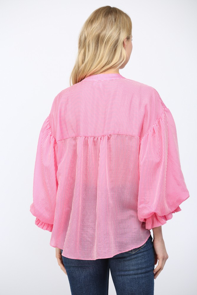 Women wearing a pink striped button up blouse on a white background.