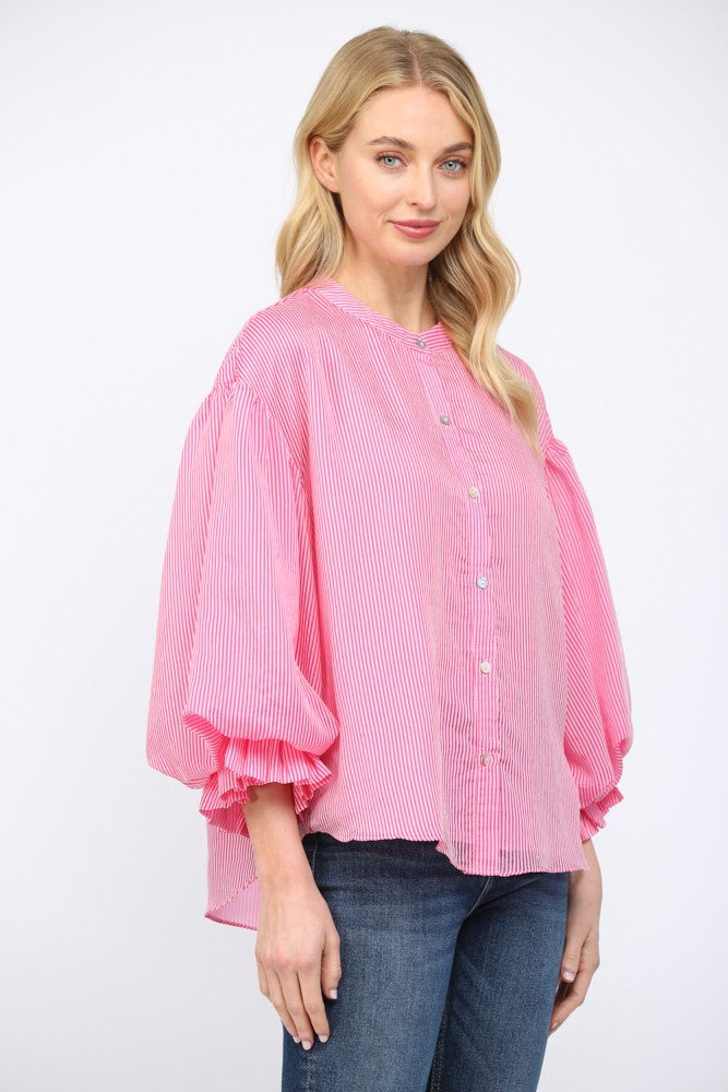Women wearing a pink striped button up blouse on a white background.