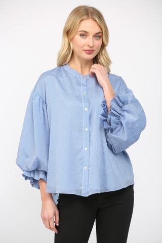 Women wearing a blue stripe blouse with black jeans on a white background.