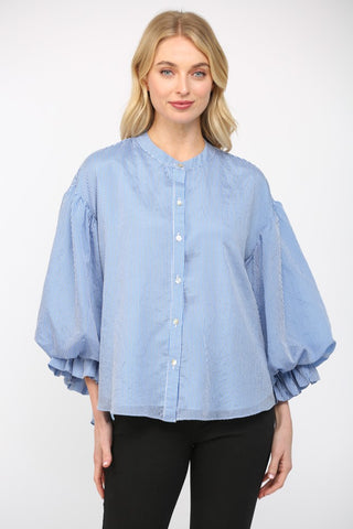Women wearing a blue stripe blouse with black jeans on a white background.