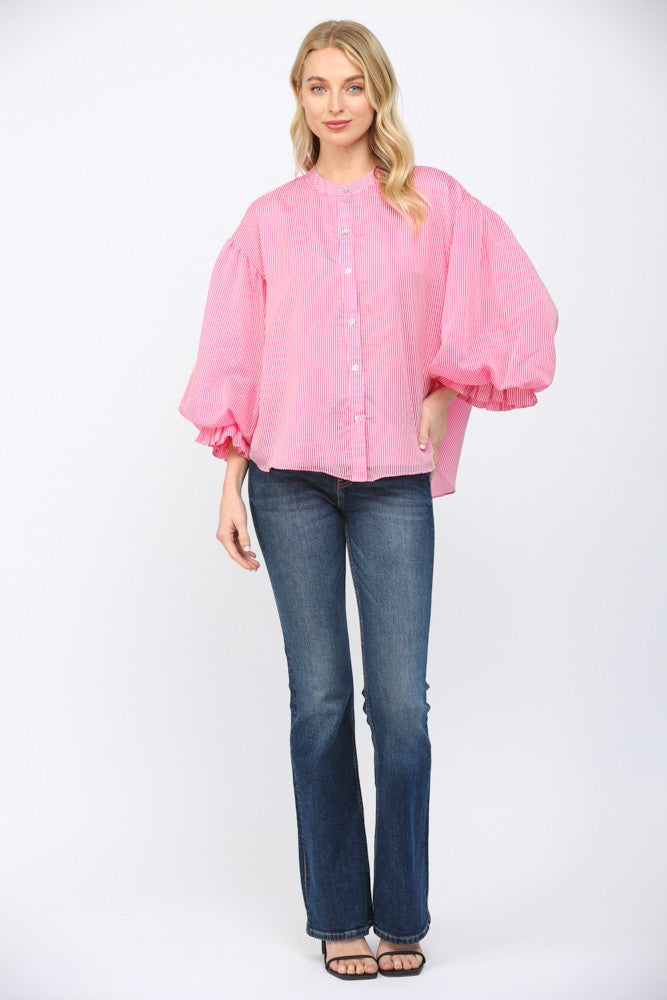 Women wearing a pink striped button up blouse on a white background.