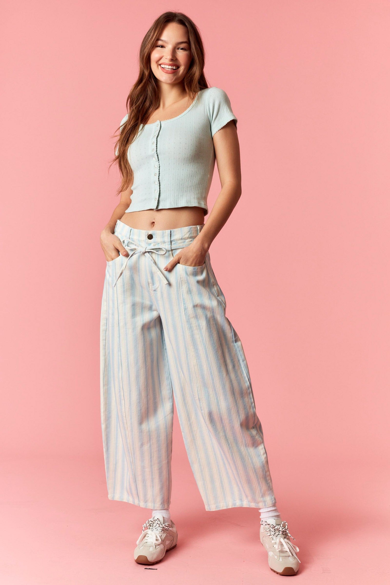Women wearing a blue and white stripe barrel pants