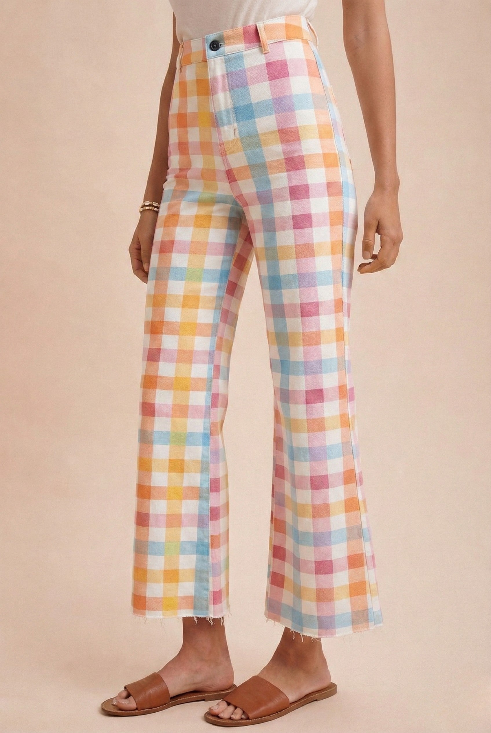 Pastel checkered pants worn by a person on a beige background