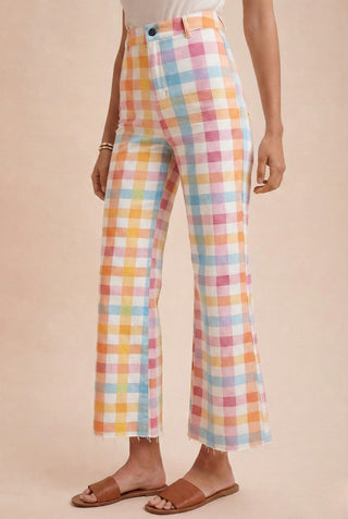 Pastel checkered pants worn by a person on a beige background