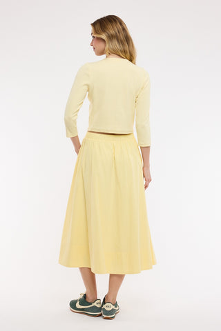 Woman wearing a yellow outfit on a white background
