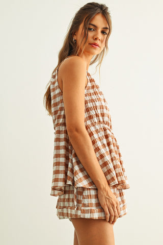 Woman wearing a checkered dress on a white background