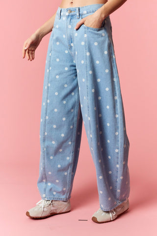 Women wearing a polka dot barrel jean on a pink background.