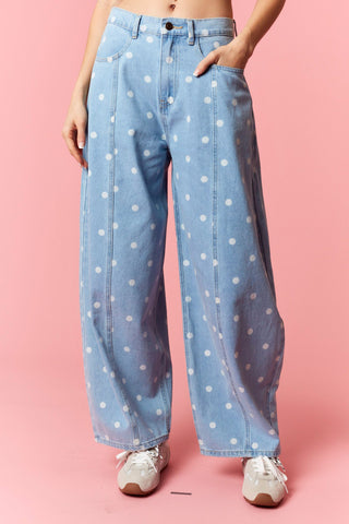 Women wearing a polka dot barrel jean on a pink background.
