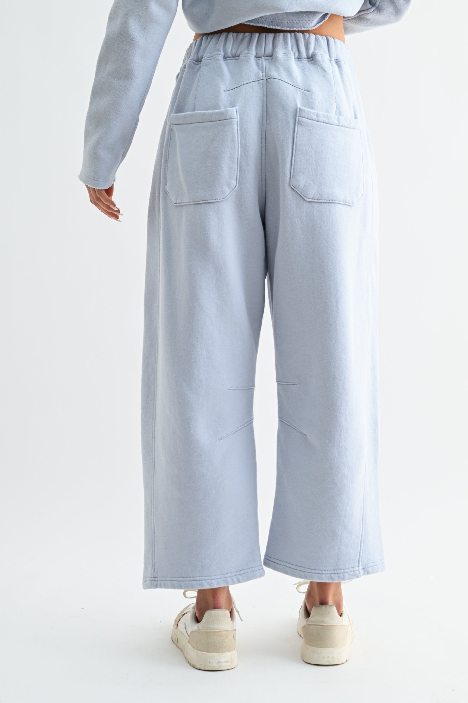 Light blue pants worn by a person on a white background