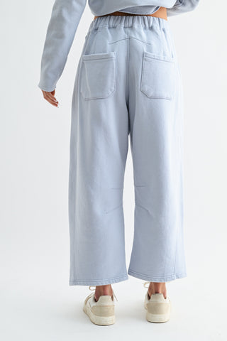 Light blue pants worn by a person on a white background