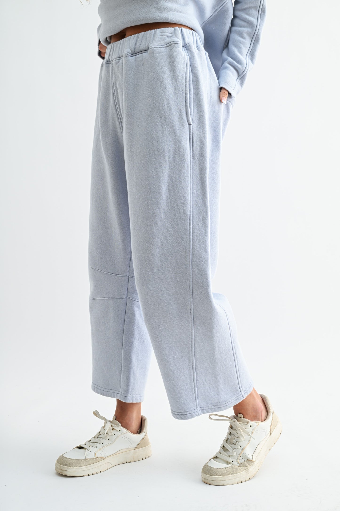 Light blue pants worn by a person on a white background