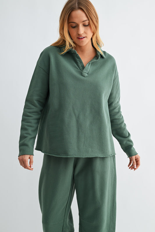 Woman wearing a green fleece outfit on a light gray background