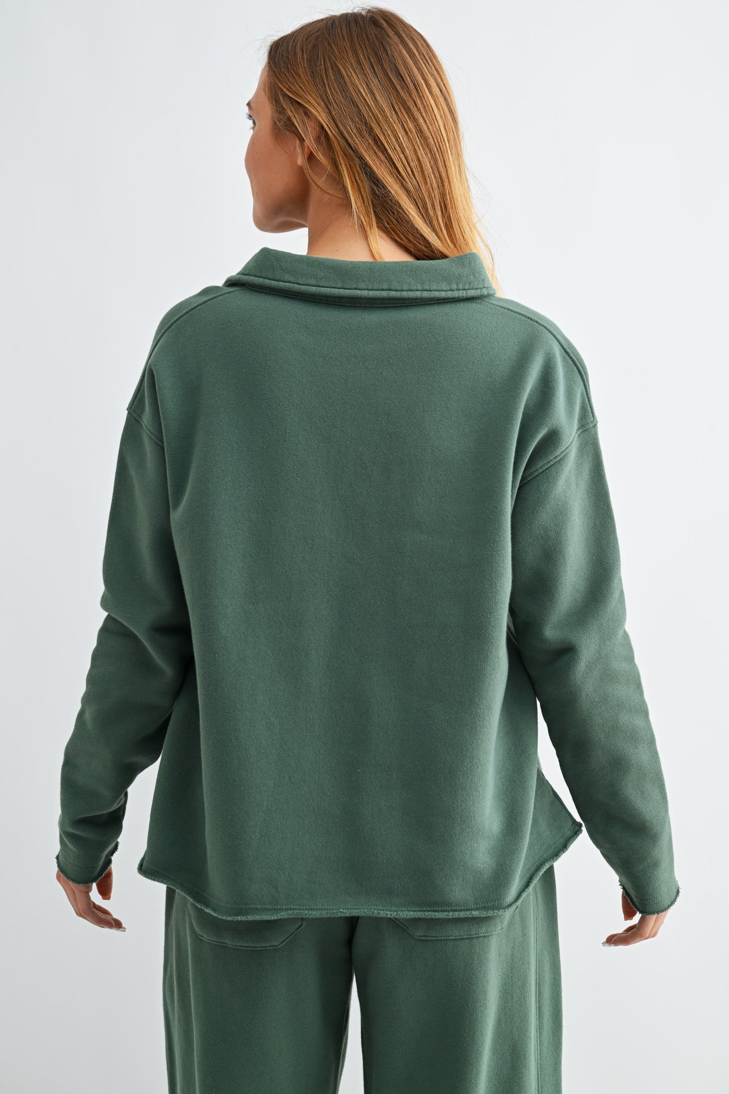 Person wearing a green fleece outfit on a white background