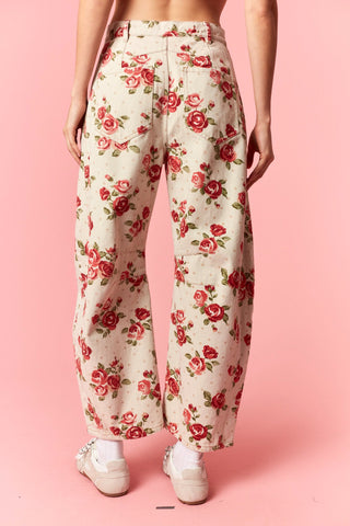 Floral pants with red roses on a pink background