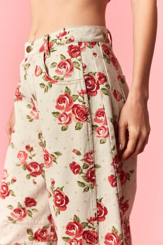 Floral pants with red roses on a pink background