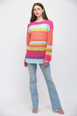 Women wearing a striped bright colour sweater and blue jeans.