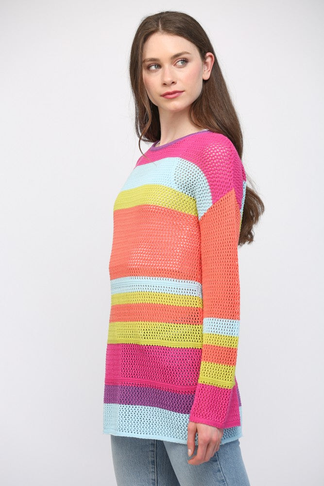 Women wearing a striped bright colour sweater and blue jeans.