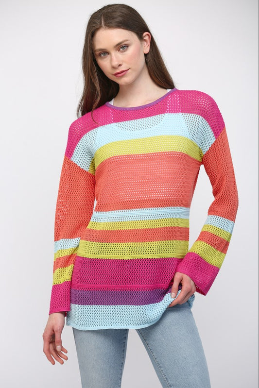Women wearing a striped bright colour sweater and blue jeans.